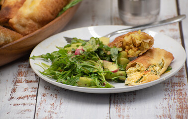 Assorted eggrolls in wooden boat dish