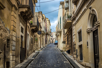 Fototapeta na wymiar Via Archimede, street in historic part of Noto city, Sicily in Italy