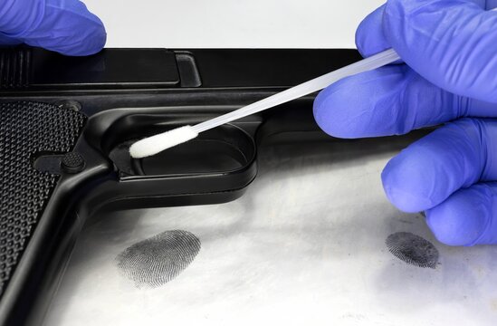 Collecting with a sterile swab a sample of possible DNA traces left by the perpetrator on a murder