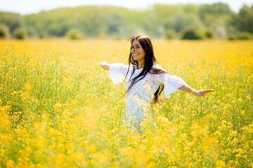 Young woman in the rapeseed field