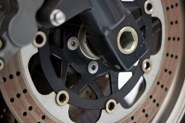 Motorcycle disc brake bracket and front wheel hub