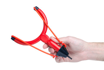 Red plastic slingshot in hand on white background isolationwhite background isolation