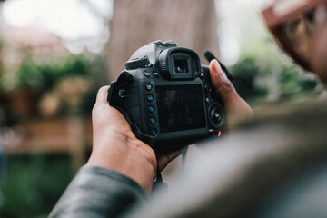 Close up of hands taking photographs with digital camera