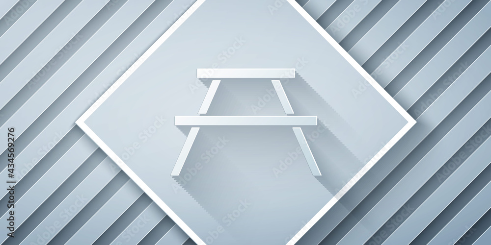 Poster paper cut picnic table with benches on either side of the table icon isolated on grey background. pa