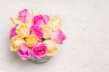 Fototapeta na wymiar Bouquet of fresh multicolored roses in a vase