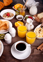 Cup of coffee, juice, eggs, fruits, toasts. Breakfast concept.