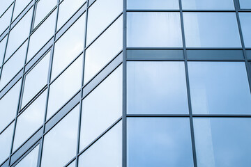 Blue glass wall of skyscraper, modern building, windows texture. Geometric abstract pattern. Architectural steel surface, background. Fragment of urban metal reflection structure. Business center.
