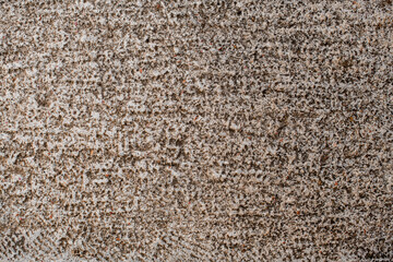 close-up of stone texture with many holes and scratches on it