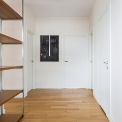 White corridor with wooden floor