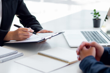 Male employer holding resume talking with female job candidate at interview, black millennial girl...