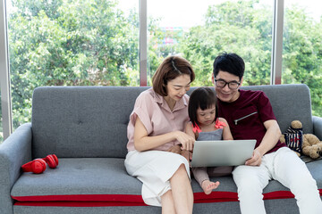 Girls with cerebral palsy learn, laugh, play father and mother in the white bedroom teach to see teaching materials and learning development of disabled children with Notebook. Happy education concept