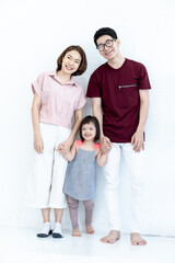 Father and mother, children, girls, disabilities and cerebral development, down syndrome, photographed portraits. The family stood happily smiling together on a white background.
