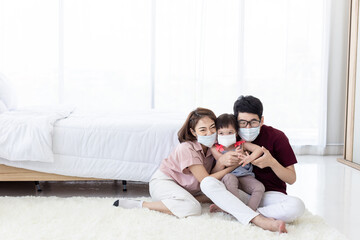 The Asian Family wore a face mask. a healthcare concept.