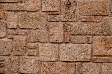 Part of wall with beautiful shell rock bricks masonry. Texture of natural stones.