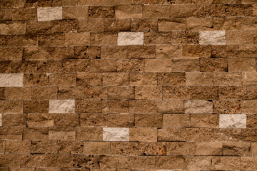 Stone wall as a background or texture. Beautiful brown shell bricks masonry.