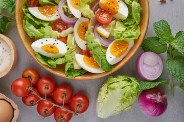 Diet menu. Healthy salad of fresh vegetables - tomatoes, egg, Onion. high angle view of a nutritious vegetable salad with boiled egg slices, served.  Healthy meal concept.