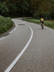 Obraz premium Cyclist riding along a road. Road cycling.