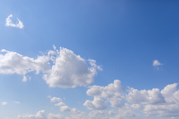 Morning fresh blue sky with white clouds with sunlight from left (perspective to the horizon)