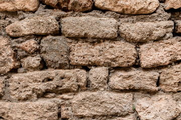 Close-up of shell rock block masonry at wall. Texture of natural stones.