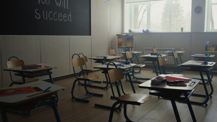 Classroom with desks and chairs in school. Interior of elementary school class