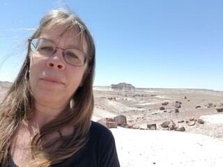 Solo travel selfie of a 52 year old woman outdoors at the Petrified Forest National Park in Arizona USA.