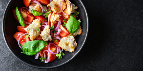 tomato salad panzanella veggie croutons, onion, olive oil, rusk on the table healthy food meal snack copy space food background rustic. top view vegan vegetarian food