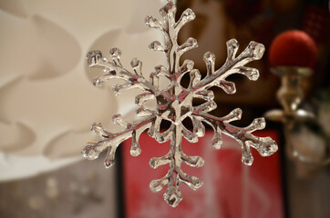 Close up photo of transparent snow flake Christmas decoration 
