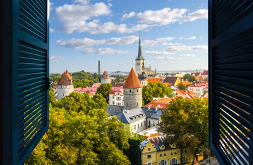 View through an open window of the medieval walled Old Town center of Tallinn Estonia along the...