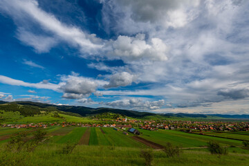 Fototapeta na wymiar View from the top of a hill, hungarian village in Transylvania, Romania at springtime.