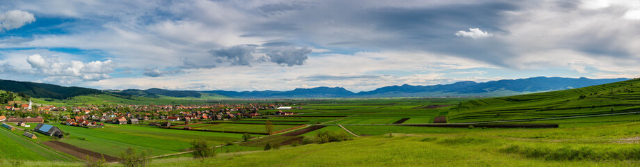 Panoramic landscape of a hungarian village in Transylvania, Romania at springtime.
