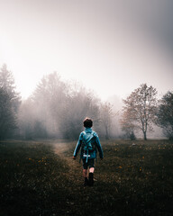 Boy walking in an enchanted magical forest. Mystical and scary place. 