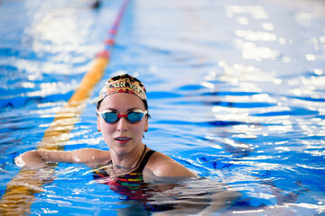 Swimming workout in the sports pool. The coach shows a swimming master class.