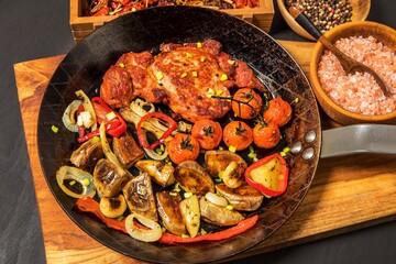 Meat, Pork neck in marinade and on a steel pan. Pork neck with baked potatoes and vegetables with chili.