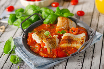 Delicious grilled fish with tomato sauce