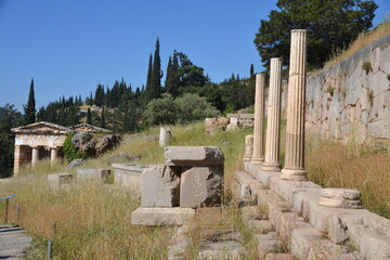 Delphi Greece with the ruins of Stoa of the Athenians on the right and the Treasury on the left - obrazy, fototapety, plakaty