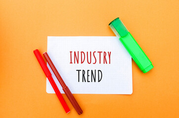 Notes with the inscription Industry trend and a markers. The concept of searching for new ideological trends and tendencies. Exclusive modern trend. Popular and relevant topics.