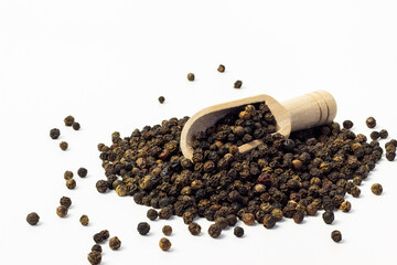 closeup of black peppercorns with wooden spatula. macro photography. Spices for cooking food.