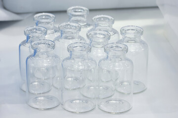 Empty glass medicine bottles, close-up view, low-grip