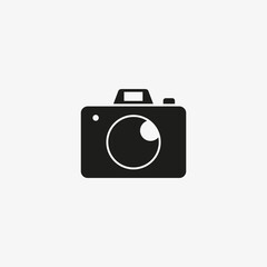 Photo camera flat of black color. Vector photography icon on white background