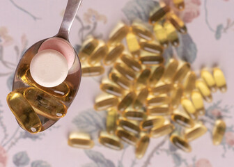 Flat lay with pills on white background with flowers