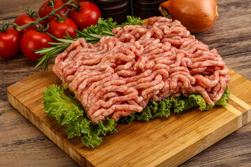 Raw pork minced meat over board