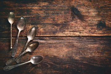 Metal spoons on wooden table