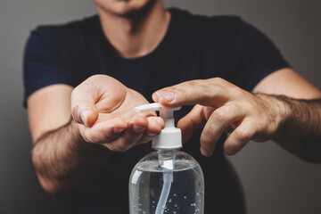 man picks up an antiseptic in his hand