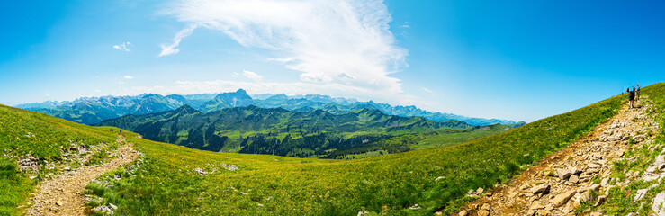 Fototapeta na wymiar Trekking in European Alps, Kleinwalsertal, Vorarlberg, Austria. View from the plateau of mountain Hoher Ifen (2230m) southwards over Algau Alps, on the left mountain Grosser Widderstein (2533m)