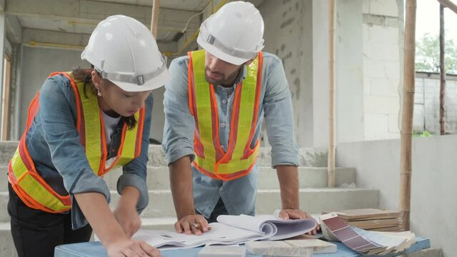Engineering team working at building site meeting and discussing on paperwork . Team onsite of architecture inspector and discuss together