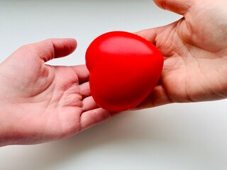 Hands with red hearts. Copy space. Isolated on white background.