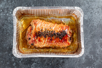 Baked pork roll with mushrooms and spices. Top view.