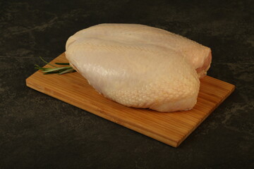 Raw whole chicken breast with skin