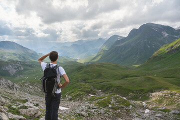 Young hiker look at the wonderful panorama in the swiss alps