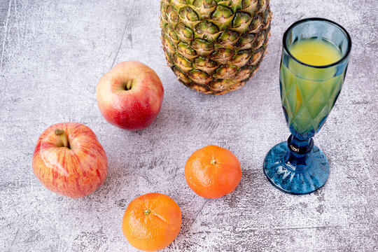 variety of fruits and juices such as pineapple, apple, tangerine and orange juice